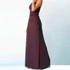 Burgundy strapless gown with a high slit on a light blue background